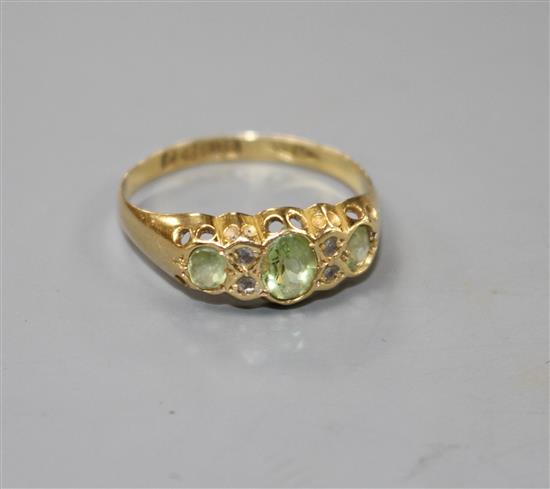 An early 20th century 18ct gold, green tourmaline and diamond chip set half hoop ring,